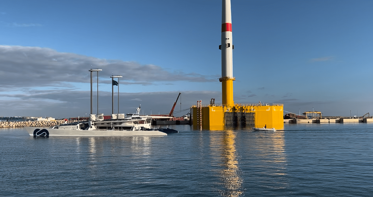 The Energy Observer boat arrives in Port-La Nouvelle, passing one of the floating wind turbines belonging to the Eolmed project, operated by Qair.